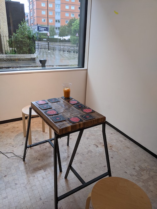A table with beer mats in a gallery